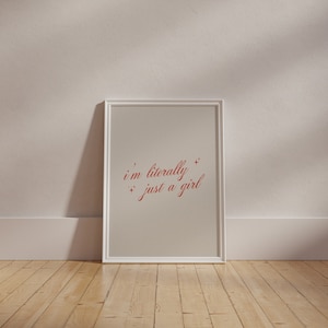 May include: A white framed print with a beige background and red text that reads "i'm literally just a girl" with small stars around the text.