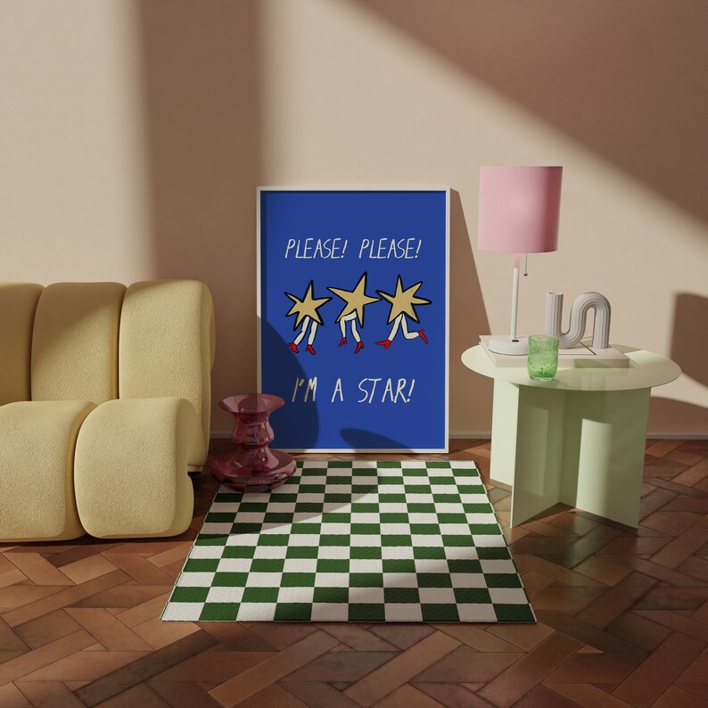 May include: A blue poster with the text "PLEASE! PLEASE! I'M A STAR!" and three yellow stars with red shoes. The poster is hanging on a light pink wall above a green checkered rug.