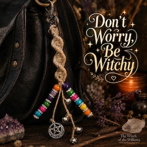 May include: A macrame keyring featuring a twisted tan cord, two strands of multi-coloured beads with silver spacers, small silver bells, and a circular silver pentacle charm. The text "Don't Worry, Be Witchy" is displayed in elegant script.