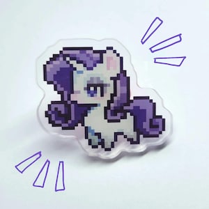 May include: A pixelated, white unicorn with a purple mane and tail. The unicorn is standing on a clear acrylic background.