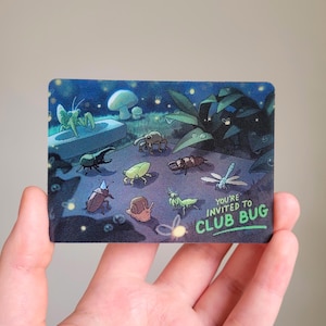 May include: A rectangular card featuring a nighttime forest scene with various insects, including a beetle, snail, and dragonfly. The text reads, "YOU'RE INVITED TO CLUB BUG," set against a dark blue background with glowing fireflies and mushrooms.