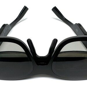 May include: Black 3D glasses with a foldable design. The glasses have a dark gray lens and a black frame.