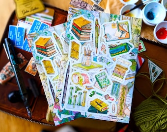 May include: A set of colorful stickers featuring illustrations of various stationery items, including notebooks, pens, pencils, and washi tape. The stickers are on a white background with a watercolor effect. The text "KINGS CROSS Hand Illustrated London" is visible in the bottom right corner.
