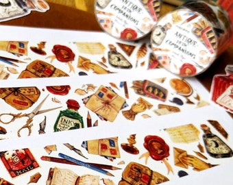 May include: Three rolls of washi tape with a vintage aesthetic featuring illustrations of ink bottles, pens, pencils, envelopes, and other stationery items. The tape is white with a repeating pattern. The text on the tape reads "Antique Ink Companions".