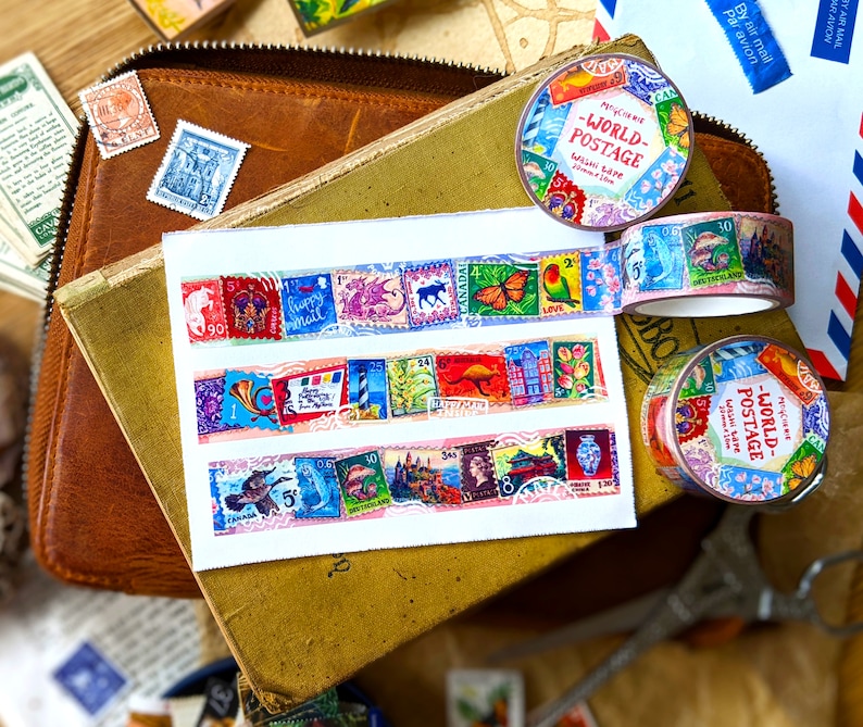May include: Three rolls of colorful washi tape with a vintage postage stamp design. The tape features images of butterflies, flowers, and other designs. The text on the tape reads "World Postage" and "Washi Tape".