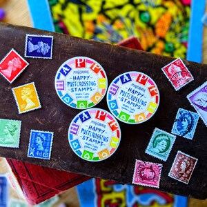May include: A collection of colorful round stickers with the text "Magcherie - Happy Postcrossing Stamps" and a variety of colorful postage stamps. The stamps feature different designs, including a portrait of a woman, a bird, and a floral pattern.