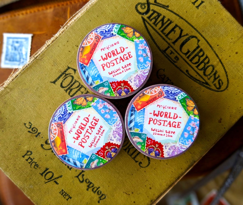 May include: Three rolls of colorful washi tape with a vintage world postage stamp design. Each roll is 20mm wide and 10 meters long. The tape features a variety of stamps with different countries and denominations.