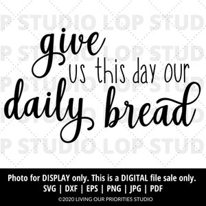 May include: Black and white text graphic that reads "give us this day our daily bread".