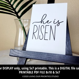May include: A printable 8x10 and 5x7 inch digital download of a white background with black text that reads "he is RISEN".