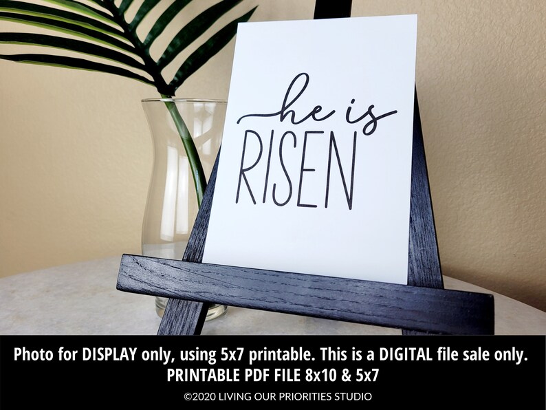 May include: A printable 8x10 and 5x7 inch digital download of a white background with black text that reads "he is RISEN".