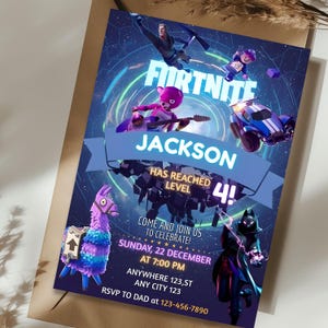 May include: A Fortnite-themed birthday party invitation with a blue background and various game characters. The invitation reads "JACKSON HAS REACHED LEVEL 4!" and includes party details: date, time, and location. A llama and other game elements are also featured.