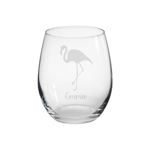 May include: A clear glass wine glass with a flamingo etched on the side. The name "Emma" is etched below the flamingo.
