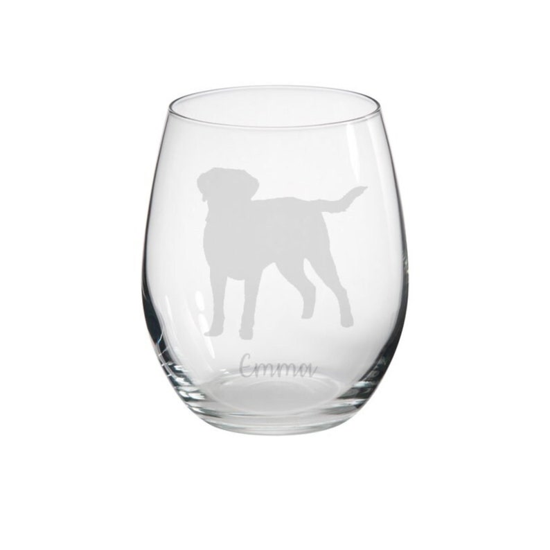 May include: A clear glass wine glass with an etched silhouette of a Labrador Retriever and the name "Emma" at the bottom.