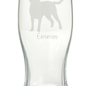 May include: A clear glass pint glass with an etched silhouette of a dog and the name "Emma" underneath.