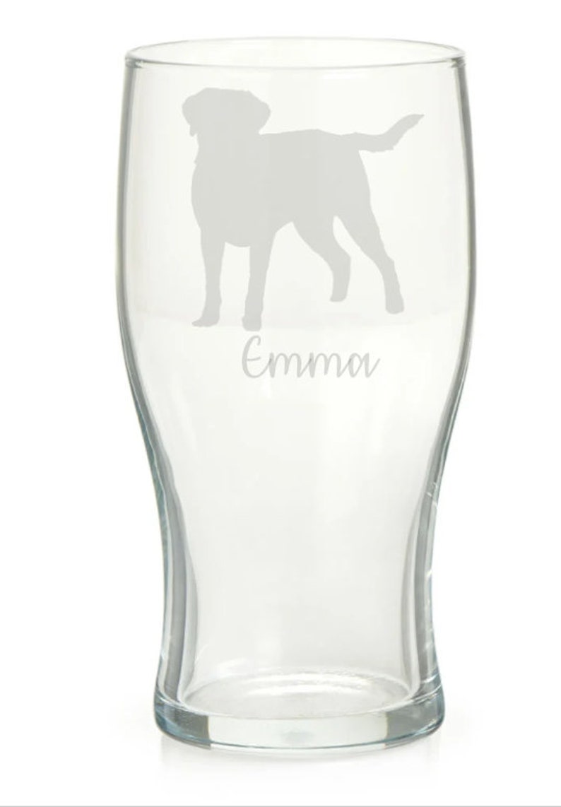 May include: A clear glass pint glass with an etched silhouette of a dog and the name "Emma" underneath.