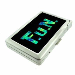 May include: A silver cigarette case with a black background and the word "FUN!" in green and blue letters with a floral pattern.