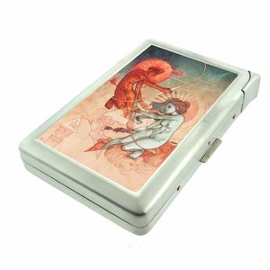 May include: A silver cigarette case featuring a colourful illustration of a man and woman in a stylised, geometric design. The case has a hinged lid and a metal clasp.