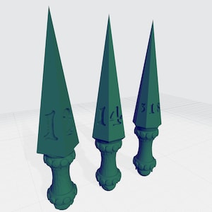 May include: Three dark green, triangular-shaped daggers with a decorative base. The daggers are numbered 1:3, 1:4, and 3:18.