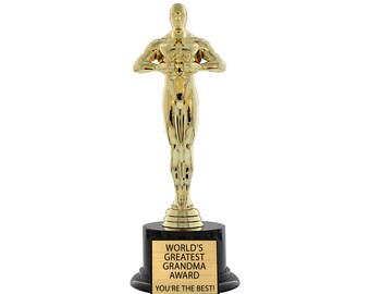 May include: A gold-colored statuette award with a black base. The base has a gold plaque that reads "World's Greatest Grandma Award You're the Best!"