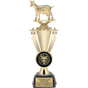 May include: A gold trophy with a goat figurine on top. The trophy has a black base with the words "The G.O.A.T. Greatest of All Time" and "Your message goes here Professionally Laser Engraved".