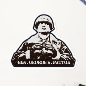 May include: A black and white silhouette of General George S. Patton, wearing a military helmet and holding binoculars. The text "GEN. GEORGE S. PATTON" is below the image.