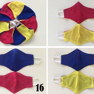 May include: Four fabric face masks in yellow, blue, and pink. The masks are arranged in pairs, with the top pair labeled "15" and the bottom pair labeled "16" and "17".