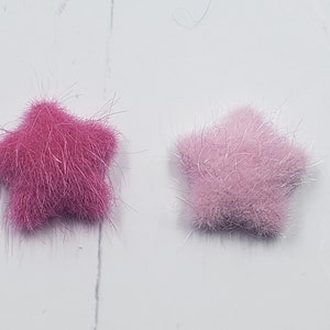 May include: Two fuzzy star-shaped embellishments, one pink and one light pink.
