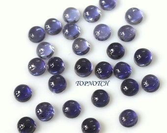 May include: A collection of 25 round, smooth, dark blue gemstones. The gemstones are approximately 6mm in diameter and have a polished finish.