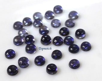 May include: A collection of 25 round, dark blue gemstones. The gemstones are smooth and polished, with a slight sparkle.