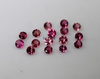 Puede incluir: Una colección de 15 piedras preciosas redondas de color rosa. Las piedras preciosas son de varios tonos de rosa, desde claro hasta oscuro.