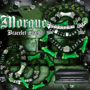 May include: A stack of bracelets featuring black, clear, and neon green beads, including bone-shaped beads and letter beads spelling PRETTIEST GIRL IN THE MORGUE and FUTURE CORPSE. The text Morgue Bracelet Stack is visible in the upper left corner.