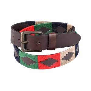 May include: A brown leather belt with a silver buckle. The belt has a colourful woven pattern in red, green, navy, and tan. The belt is designed with a classic buckle closure.