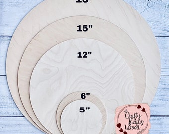 May include: Five unfinished wooden circles of varying sizes, measuring 5", 6", 12", 15", and 18". The circles are arranged in a nested pattern, with the smallest circle in the center and the largest circle on the outside. The circles are all made of light-colored wood and have a smooth surface.