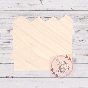 May include: Unfinished wooden cutout of a picket fence with a scalloped top. The cutout is on a whitewashed wood background. The text "The Crafty Heifer's Wood Creations" is visible in the lower right corner of the image.