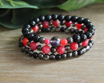 Stapel armband met zwarte en felroze glaskralen - elastische rekbare armband