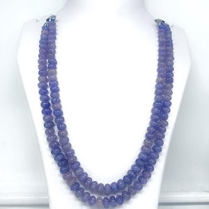 May include: A double strand necklace made of light blue and purple beads. The beads are round and have a smooth, polished finish.