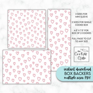 May include: Printable PDF template for box backers with a pink heart pattern. Includes three sizes for mini sleeves, two sizes for single cookie boxes, a 4.5 x 7.5 inch size for a box of two cookies, and a full page size to cut to any size. The text "the Cookier Club" is in the bottom right corner.