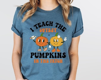 May include: A heather teal t-shirt with the text "I teach the cutest pumpkins in the patch" and a graphic of two smiling pumpkins holding hands.