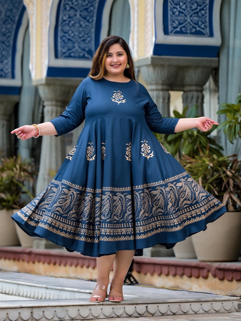 May include: A blue and gold printed maxi dress with a flared skirt. The dress has a round neckline and three-quarter sleeves.