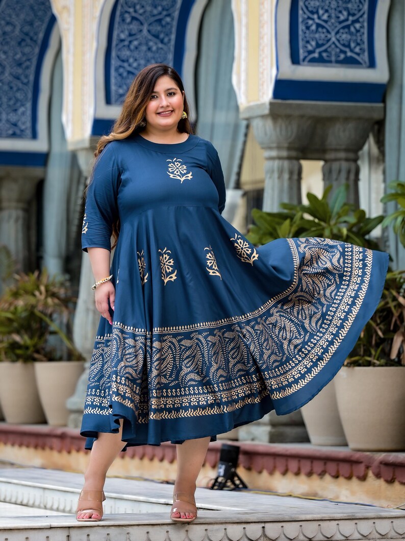 May include: A blue and gold printed maxi dress with a flared skirt. The dress has a round neckline and three-quarter sleeves.