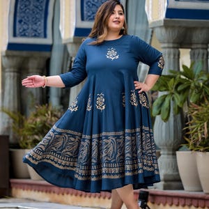 May include: A blue and gold printed maxi dress with a flared skirt and three-quarter sleeves. The dress has a floral pattern and a gold border.
