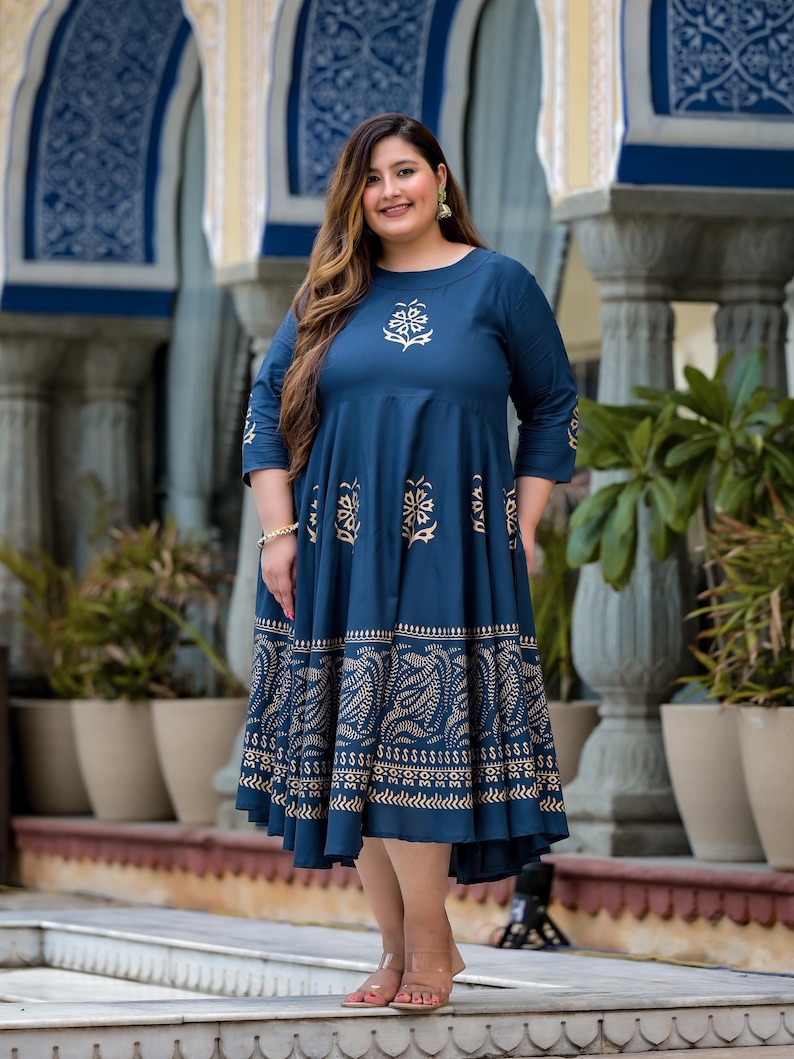May include: A blue and gold printed maxi dress with a round neckline and three-quarter sleeves. The dress has a flowing skirt and a floral pattern.