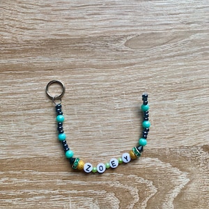 Kpop Demon Hunters &#39;Zoey&#39; keyring. A inspired beaded keyring for fans of the movie and character
