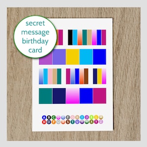 May include: A white card with the words "secret message birthday card" in a green circle. The card features a colour chart with various shades of blue, pink, purple, yellow, green, and brown. The letters of the alphabet are arranged in a circle around the colour chart.