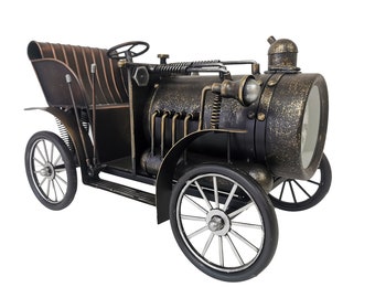 May include: A vintage-style metal car clock with a black and gold finish. The clock has a round face with Roman numeral markings and a black hand.