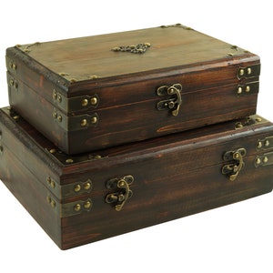 May include: Two wooden boxes with brass hinges and clasps. The top box is closed and the bottom box is open. The boxes are made of dark wood and have a rustic look.