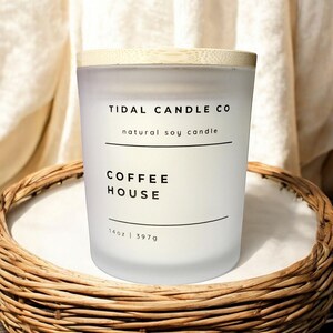 May include: White frosted glass candle jar with a bamboo lid. The candle is labeled "TIDAL CANDLE CO natural soy candle COFFEE HOUSE 14oz | 397g"