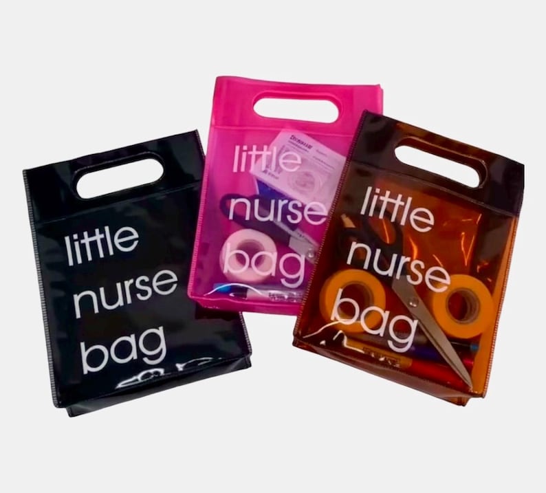 May include: Three transparent tote bags with a handle cut-out. Each bag has the words "little nurse bag" printed in white. The bags are black, pink, and brown, and contain medical supplies like tape and scissors.