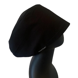 May include: A black cotton scrub hat with the text "Xxcode Designs" embroidered on the side.