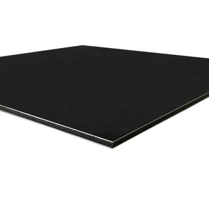 May include: A black rectangular panel with a silver edge. The panel has a smooth, matte finish and is angled slightly towards the viewer, showcasing its clean lines and modern aesthetic.
